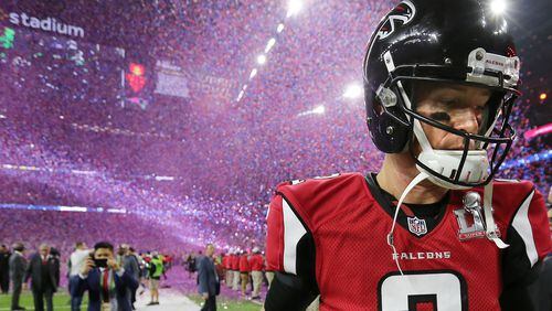 February 5, 2017, Houston: A dejected Matt Ryan walks off the field as the confetti flys falling to the Patriots 34-28 in the Super Bowl on Sunday Feb. 5, 2017, in Houston. Curtis Compton/ccompton@ajc.com