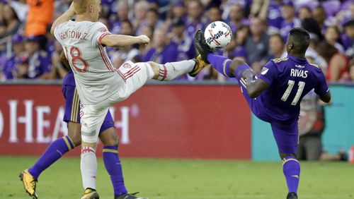 Atlanta United's Jeff Larentowicz (18) and Orlando City's Carlos Rivas (11) vie for possession of the ball during the first half of an MLS soccer match, Friday, July 21, 2017, in Orlando, Fla. (AP Photo/John Raoux)