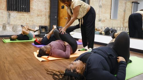 Instructor Cassandra Young, right, reacts as she assists Tracina Porter of Dallas during a yoga session at Abounding Prosperity, a Dallas-based HIV advocacy group, Tuesday, Dec. 13, 2022. They hold dance & fitness classes, job interview prep classes and more with the goal of treating the whole person, not just HIV. Photos: Shafkat Anowar/The Dallas Morning News

The Dallas Morning News