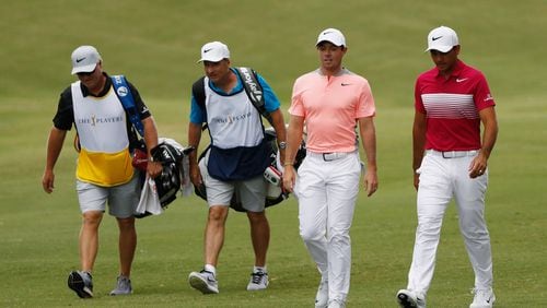 A couple guys familiar with the complaints of the back - Rory McIlroy and Jason Day - enjoy their stroll at the Players Championship Saturday. (Sam Greenwood/Getty Images)