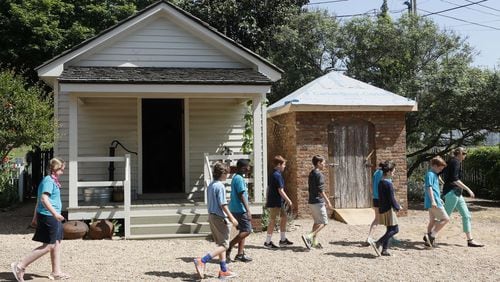 May 2, 2019 - Marietta - West Side Elementary School students from Marietta tour the Root House. The kitchen (left) was reconstructed in the 90’s from the same old insurance records that are currently being used to reconstruct the smokehouse (right). Cobb Landmarks is renovating its William Root House Museum, an old house in downtown Marietta that showcases the lives of people in antebellum Georgia. They have began reconstructing the smokehouse and a log cabin on to the site. Bob Andres / bandres@ajc.com