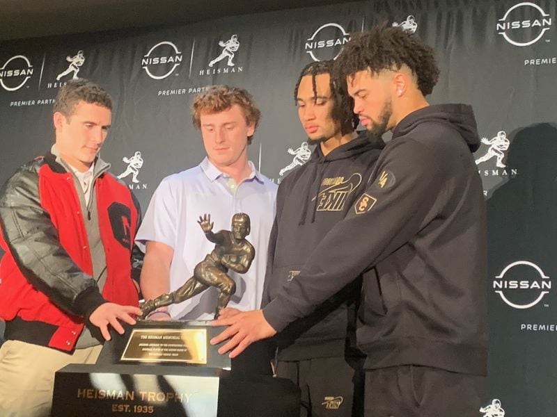 The four finalists for the 2022 Heisman Trophy (from left to right) Stetson Bennett, Max Duggan, C.J. Stroud and Caleb Williams pose with the trophy Friday in New York.