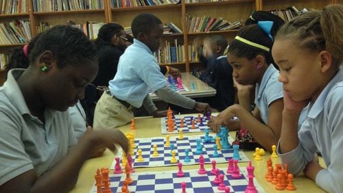 Fifth graders Vandasia Louis, 11, and Jerrinya Smith, 11, play chess at Baton Rouge's Celerity Lanier Charter School. Jaime Sarrio jsarrio@ajc.com