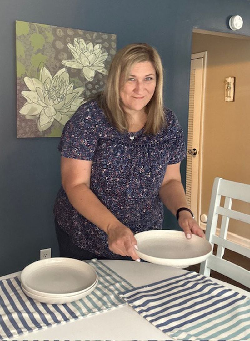 Dinner time at the Felzer home is more than eating the evening meal together. They share the best and worst things from the day and discuss what is happening the next day. Sometimes they use cards they got from the therapist to start a conversation or dig a little deeper on a matter. (Shown is foster mom Stacey Felzer setting the table).
