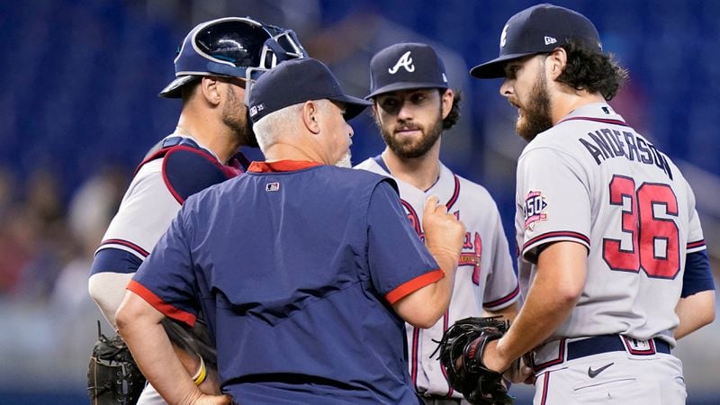 Braves pitching coach Rick Kranitz (front left) talks with starting pitcher Ian Anderson (36) during the first inning against the Miami Marlins, Sunday, July 11, 2021, in Miami. (Lynne Sladky/AP)