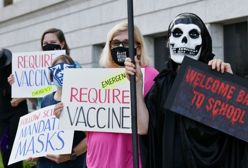 A group of protesters from the United Campus Workers of Georgia, Local 3265, rally last month, urging the University System of Georgia to institute a policy requiring everyone to wear masks or be vaccinated to be on campus. (Hyosub Shin / Hyosub.Shin@ajc.com)