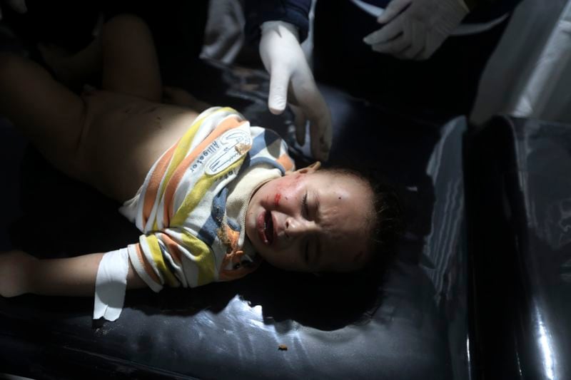 EDS NOTE: NUDITY - Palestinian medics treat a wounded child in the Israeli bombardment of the Gaza Strip at the Kuwaiti Hospital in Rafah refugee camp, southern Gaza Strip, late Friday, April 19, 2024. (AP Photo/Ismael Abu Dayyah)