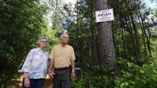 Penny and George West have anti-Rivian signs posted along their 25 acres of natural forest land surrounding their home near Madison. “Curtis Compton / Curtis.Compton@ajc.com”