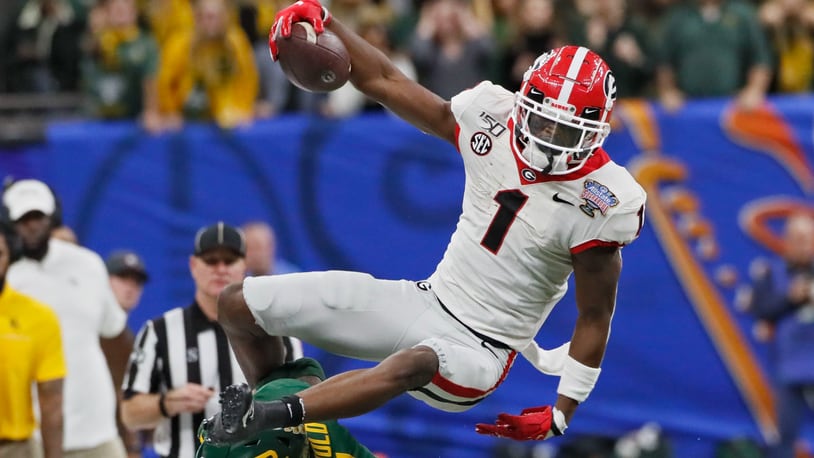 Georgia wide receiver George Pickens (1) goes airborne on a this first-down catch in the Sugar Bowl football game between the Georgia Bulldogs and the Baylor Bears at the Superdome in New Orleans on Jan. 1, 2020.  Bob Andres  bandres@ajc.com
