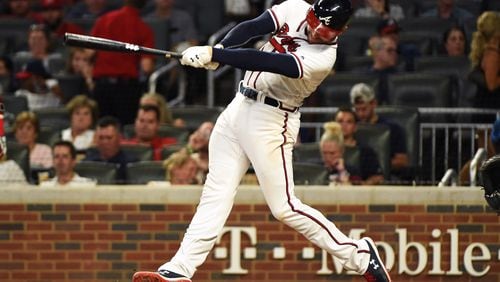 Freddie Freeman  hits a home run in the fifth inning against the Miami Marlins at SunTrust Park on Tuesday night.
