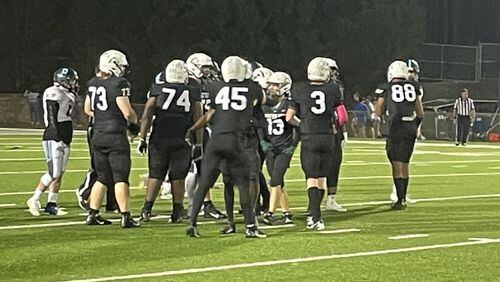 Quarterback Cayman Prangley (3) and the Kennesaw Mountain offense get in victory formation for the final play in a 21-17 victory over Pope on Oct. 15, 2021. The win left Kennesaw Mountain on top of the standings in Region 6-6A. (Photo by Chip Saye)