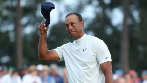 Tiger Woods tips his hat to the gallery as he leaves the 18th hole after coming within one stroke of the leaders during the second round of the Masters Tournament Friday, April 12, 2019, at Augusta National Golf Club in Augusta. Jason Getz / Special to the AJC