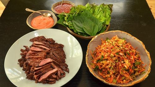 Soy-based marinated beef, Kimchi Slaw, Gochujang Sour Cream and Ssamjang with romaine and perilla leaves await assembly. (Photo by Chris Hunt/Special)
