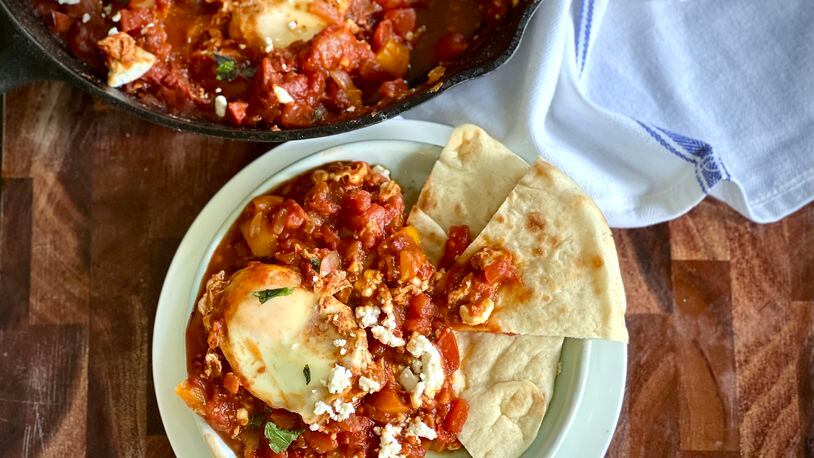 Three pounds (or more!) of garden-fresh tomatoes simmer down into a delicious, bright-tasting summer shakshuka. (Kellie Hynes for The Atlanta Journal-Constitution)