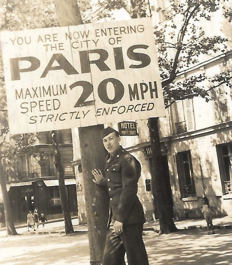 Staff Sgt. Bill King is seen under an Allied speed-limit sign in Paris, where he was stationed at the end of World War II. (Courtesy of the King family)