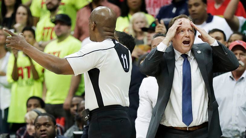 Atlanta Hawks' head coach Mike Budenholzer, right, reacts to a call by official Derrick Collins, left, in the fourth quarter in Game 1 of a first-round NBA basketball playoff series against the Boston Celtics Saturday, April 16, 2016, in Atlanta. The Hawks won 102-101. (AP Photo/David Goldman)