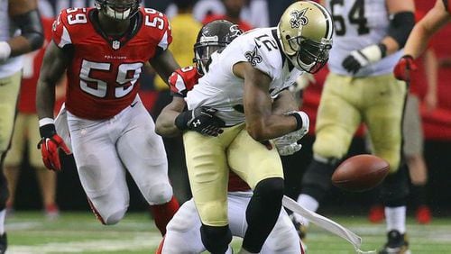 Falcons safety William Moore hits Saints wide receiver Marques Colston causing a fumble recovered by the Falcons in overtime in their NFL football game on Sunday, Sept. 7, 2014, in Atlanta. Falcons linebacker Joplo Bartu (left) recovered the fumble. The Falcons went on to kick a field goal to win the game 37-34. Moore could be back to face Cleveland on Nov. 23. (By Curtis Compton)