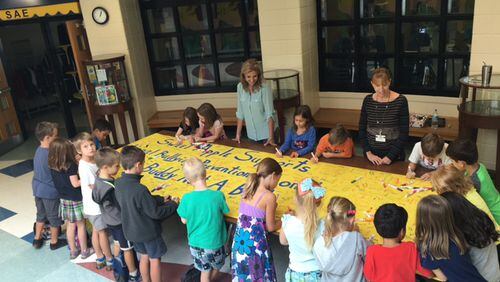 Sweet Apple Elementary students sign the school’s banner promoting an anti-bullying message.