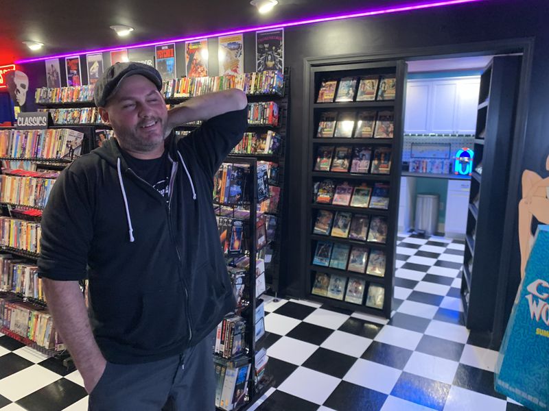 Anthony SantAnselmo of Woodstock installed the black and white checked floors in his basement to resemble a 1980s video store he imagined might be in a nook in New York City. RODNEY HO/rho@ajc.com