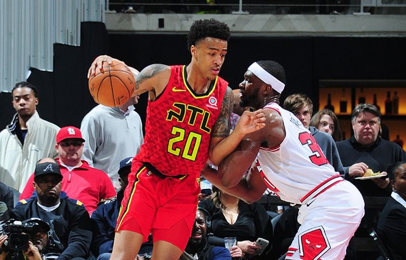 In this file photo  John Collins #20 of the Atlanta Hawks handles the ball against the Chicago Bulls on March 11, 2018 at Philips Arena in Atlanta, Georgia.  