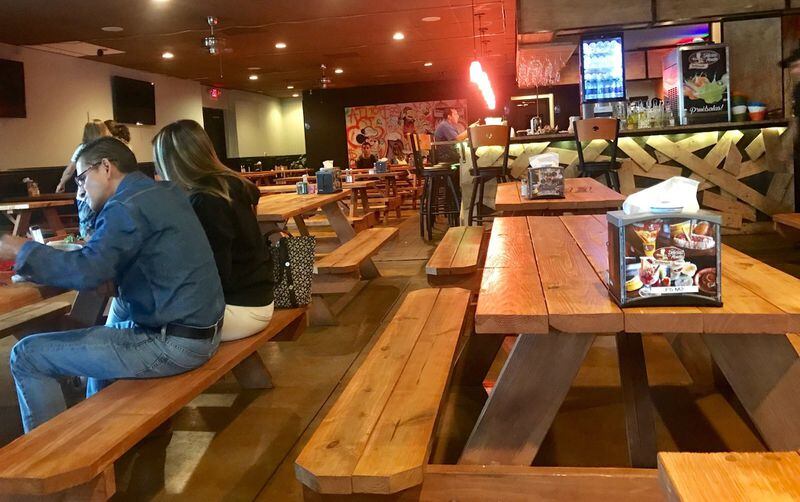 Picnic tables in the dining room add to the casual ambiance at authentic Colombian restaurant Las Delicias de la Abuela on Buford Highway. LIGAYA FIGUERAS / LFIGUERAS@AJC.COM