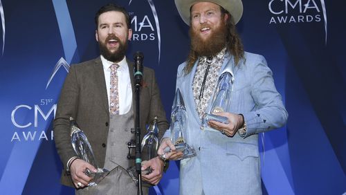 T.J., left, and John Osborne of the Brothers Osborne pose in the press room with their awards for vocal duo of the year and music video of the year at the 51st annual CMA Awards at the Bridgestone Arena on Wednesday, Nov. 8, 2017, in Nashville, Tenn. (Photo by Evan Agostini/Invision/AP)