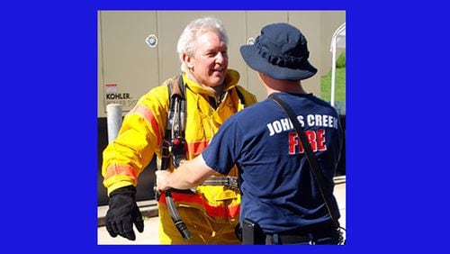 Trying on firefighting gear is one of the experiences offered to residents at the Johns Creek Citizens Fire Academy. The next academy meets for 10 sessions beginning Feb. 5. CITY OF JOHNS CREEK