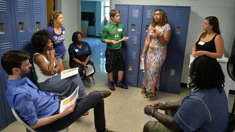 Teachers for The Kindezi Schools talk about cultural awareness during a group session at a summer workshop Thursday July 2, 2015. The successful Atlanta charter is taking over the building a failed charter and absorbing many of its students.