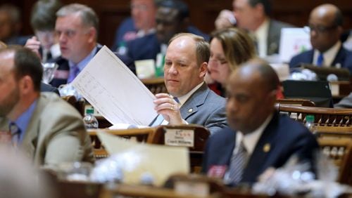 State Rep. Dan Gasaway, R-Homer, flips through the budget as the House listens to a presentation in March 2013. JASON GETZ / JGETZ@AJC.COM
