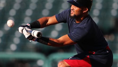Braves utility player Emilio Bonifacio works on bunting during an early spring-training workout. He was told Tuesday that he made the team. (Curtis Compton/ccompton@ajc.com)