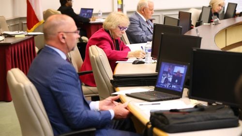 Board member Steve Knudsen (from left), chair Louise Radloff, and chief executive officer J. Alvin Wilbanks practice social distancing while the Gwinnett County Board of Education, the largest school district in the state, conducts its first work session and budget meeting in cyberspace at the Gwinnett County Public Schools Instructional Support Center in Suwanee. Radloff lost her reelection bid. Curtis Compton ccompton@ajc.com AJC FILE PHOTO