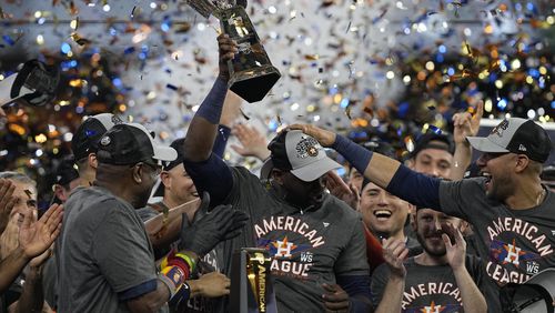 Houston Astros designated hitter Yordan Alvarez holds the trophy after their win against the Boston Red Sox in Game 6 of baseball's American League Championship Series Friday, Oct. 22, 2021, in Houston. The Astros won 5-0, to win the ALCS series in game six.(AP Photo/Tony Gutierrez)