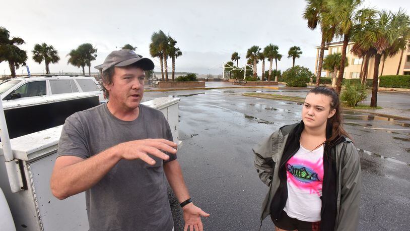 October 8, 2016 St. Simons Island - Timothy Seavey, of St. Simons Island, talks as his daughter Emily looks near St. Simons Island Pier on Saturday morning, October 8, 2016. Hurricane Matthew knocked out power, sent trees crashing down on houses and over roads and flooded parking lots and yards across St. Simons Island. Frederica Road near the air strip is covered with fallen trees. HYOSUB SHIN / HSHIN@AJC.COM