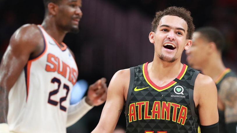 Hawks guard Trae Young is all smiles during the final minutes of a 123-110 victory over Deandre Ayton and the Phoenix Suns in a NBA basketball game on Tuesday, January 14, 2020, in Atlanta.    Curtis Compton ccompton@ajc.com