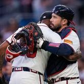 Atlanta Braves pitcher Raisel Iglesias (26) and Atlanta Braves catcher Travis d'Arnaud (16) celebrate after a win against the San Diego Padres, Monday, May 20, 2024, in Atlanta. (AP Photo/Brynn Anderson)