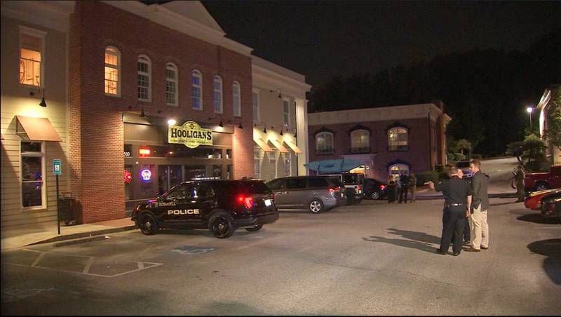 Roswell police responded to Hooligans Tavern, a popular sports bar on Holcomb Bridge Road, where a man had been shot multiple times. A suspect was arrested nearby and charged with murder.