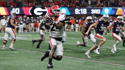 December 2, 2017 Atlanta: An attempted field goal by Auburn Tigers place kicker Daniel Carlson is recovered by Georgia Bulldogs safety Dominick Sanders (24) during the second half of the SEC Football Championship at Mercedes-Benz Stadium, December 2, 2017, in Atlanta.  Curtis Compton / ccompton@ajc.com