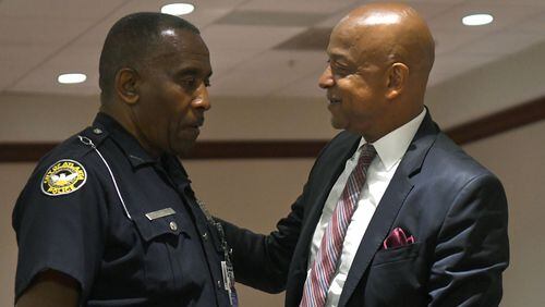 Officer C.J. Maddox Jr. (left) speaks with DeKalb County Sheriff Jeff Mann (right) before Mann pleaded guilty to charges of obstruction and prohibited conduct at Atlanta Municipal Court in Atlanta on Thursday. (REBECCA BREYER)