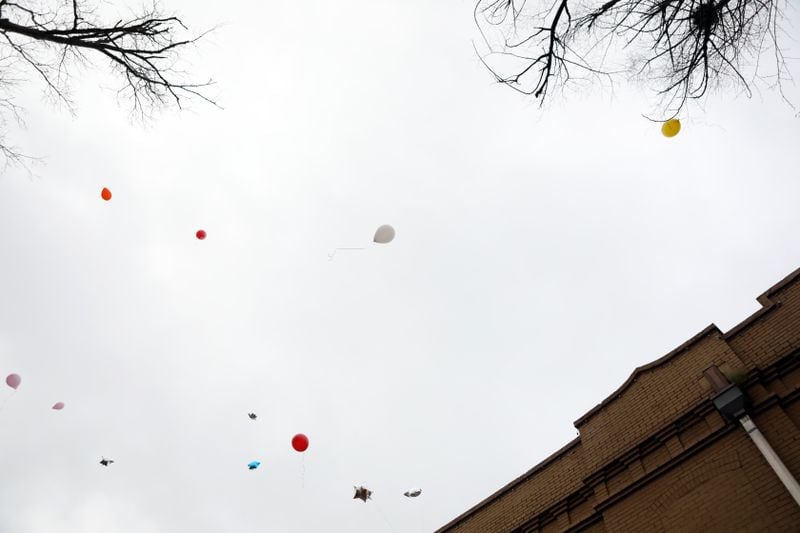 Balloons are released in memory of Anitra Gunn in front of the Eighteen36 Restaurant and Lounge, where Gunn worked, in Fort Valley on Thursday, February 20, 2020. (Photo/Leah Yetter for the AJC)