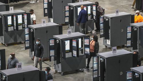 Voters cast their ballots on Dominion touchscreens during early voting in 2020 at State Farm Arena in downtown Atlanta. (John Spink / John.Spink@ajc.com)
