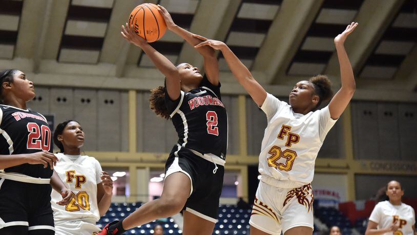 March 11, 2021 Macon - Woodward Academy's Sara Lewis (2) shoots over Forest Park's Olympia Chaney (23) during the 2021 GHSA State Basketball Class AA Boys Championship game at the Macon Centreplex in Macon on Thursday, March 11, 2021 Pace Academy won 73-42 over Columbia. (Hyosub Shin / Hyosub.Shin@ajc.com)