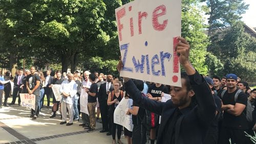 Justin Tolston holds a sign at an August 2018 “unity rally” demanding Emory University law school professor Paul Zwier be fired for using a racially-charged epithet in his class during a discussion about a discrimination case. Zwier has since apologized for the use of the word. ERIC STIRGUS / ESTIRGUS@AJC.COM