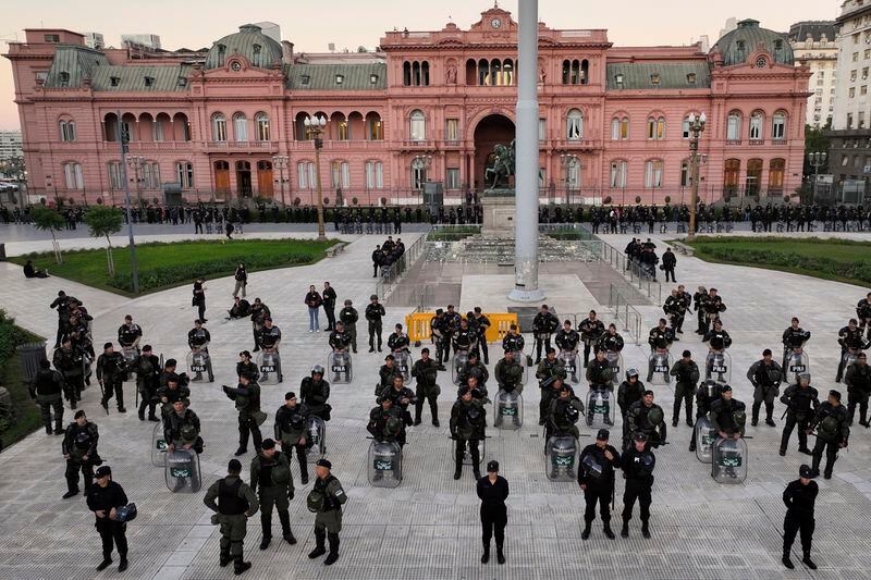 Police guard the Casa Rosada presidential palace during a march demanding more funding for public universities and to protest against austerity measures proposed by President Javier Milei, in Buenos Aires, Argentina, Tuesday, April 23, 2024. (AP Photo/Rodrigo Abd)