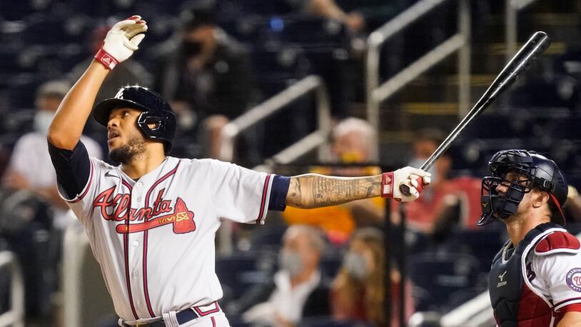 The Braves' Huascar Ynoa finishes his big swing with a flourish and watches the flight of his grand slam against Washington on May 4. (AP Photo/Alex Brandon)