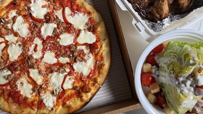 Pizza, wings and a wedge salad are among the takeaway offerings at Two Birds Taphouse in Marietta. CONTRIBUTED BY BOB TOWNSEND