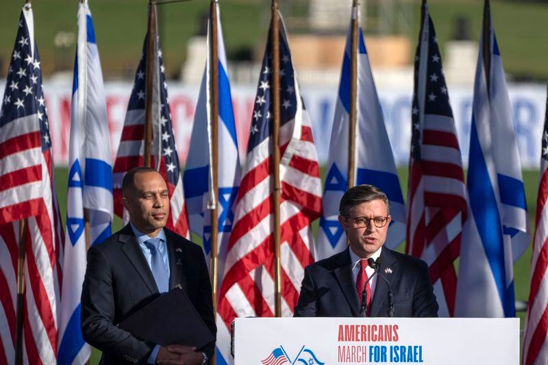 FILE - Speaker of the House Mike Johnson of La., speaks as House Minority Leader Hakeem Jeffries of N.Y., listens at the March for Israel on Nov. 14, 2023, on the National Mall in Washington. (AP Photo/Mark Schiefelbein, File)