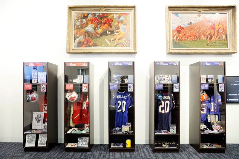 The College Football Hall of Fame presented a temporary locker exhibit that pays tribute to the 22 individuals inducted into the 2023 class. This exceptional class comprises renowned players like Tim Tebow, Reggie Bush, and Eric Berry, alongside distinguished coaches Mark Richt and Paul Johnson, who have left an indelible mark on the sport in the State of Georgia.Miguel Martinez /miguel.martinezjimenez@ajc.com