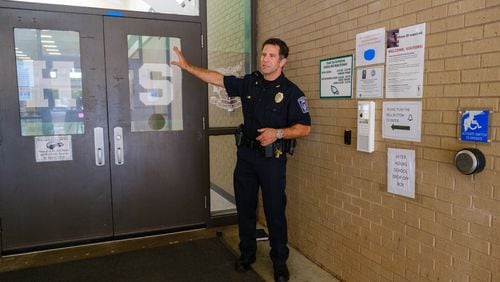 Gwinnett County Public Schools Police Chief Tony Lockard demonstrates the district’s new front entrance security and sign-in system at Collins Hill High School in Suwanee on Friday, July 22, 2022. Building security is likely to be a key education topic for Georgia lawmakers during the upcoming 2023 legislative session. (Arvin Temkar / arvin.temkar@ajc.com)