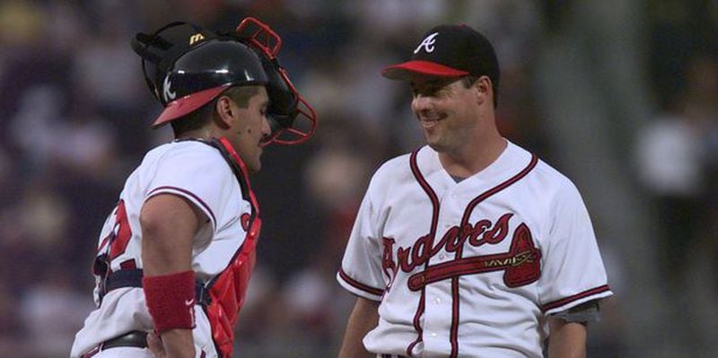 Eddie Perez talks to Greg Maddux, the future Hall of Famer who preferred that Perez catch his games with the Braves. (AJC file photo/ Dave Tulis)