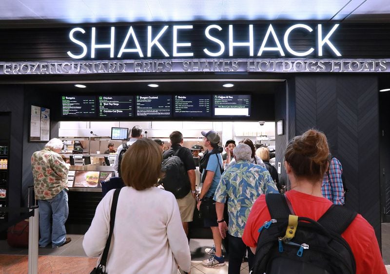 Customers line up at the Shake Shack on Concourse A at Hartsfield-Jackson International Airport after it opened last month. The popular restaurant won a spot at the airport in a contract award from 2016. CURTIS COMPTON/CCOMPTON@AJC.COM